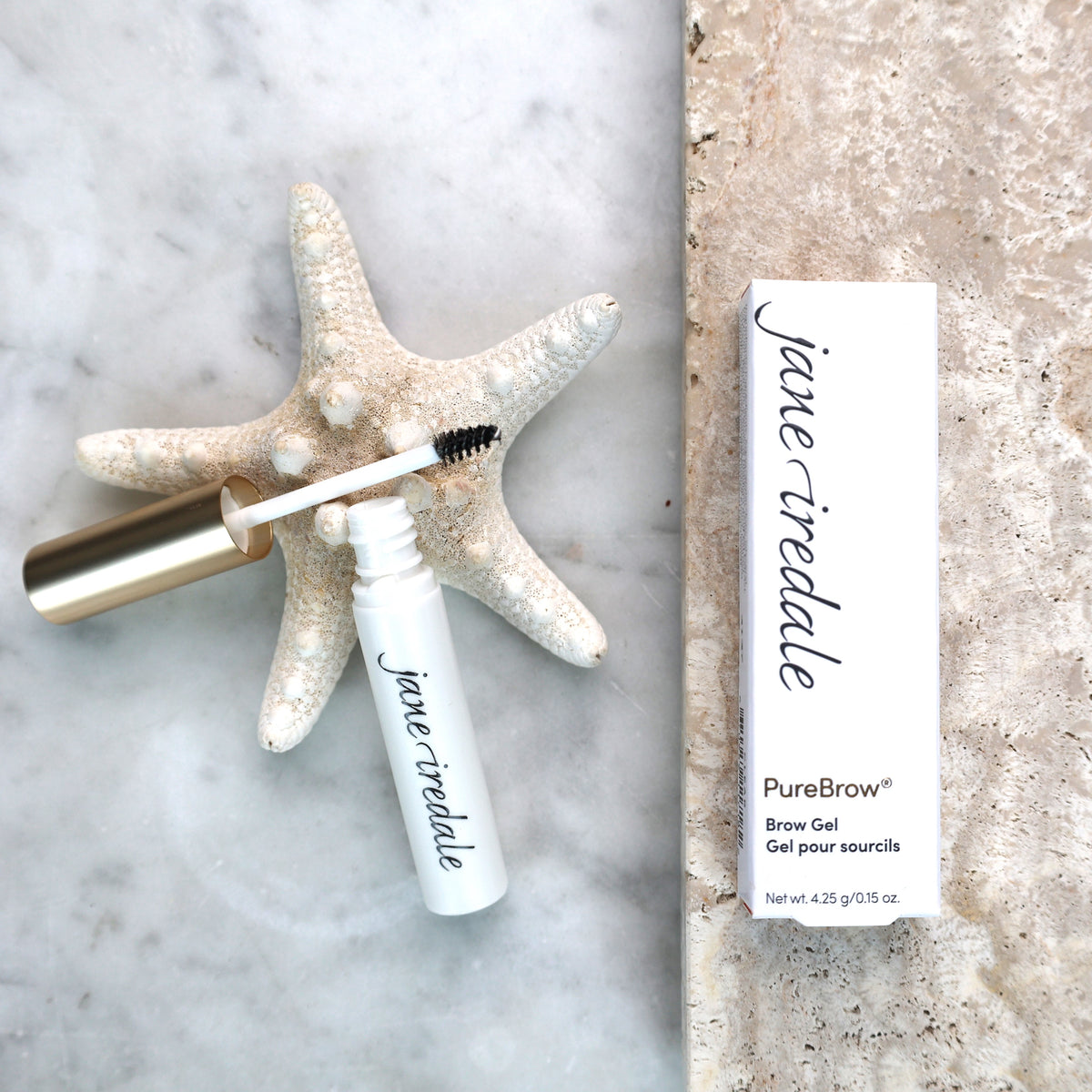Jane Iredale Purebrow Gel klar bryngelé og emballage på marmor med søstjerne